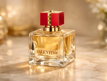 Valentino Voce Viva Eau de Parfum bottle with red cap and gold accents on marble surface