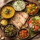 A neatly arranged Indian healthy meal spread with dal, roti, vegetables, curd, and fresh salad on a wooden table