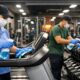 Professional cleaning staff disinfecting gym equipment in a modern fitness center