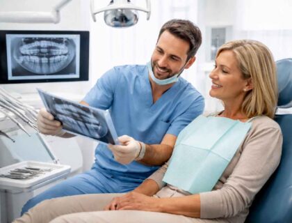 Dentist consulting patient in modern dental clinic Budapest