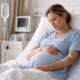 Pregnant woman receiving IV fluids in hospital for severe vomiting