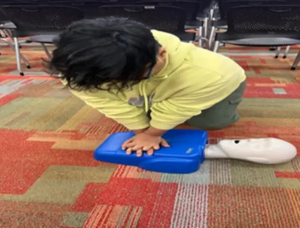 Person performing CPR chest compressions during CPR training.